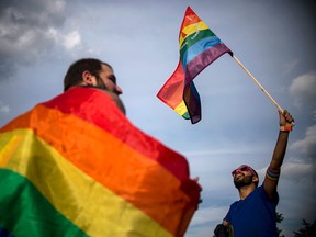 People hold rainbow flags as they take part in the annual Gay Pride Parade in central Sofia on June 10, 2017.