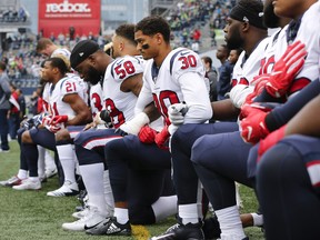 Members of the Houston Texans kneel during the national anthem before an October 2017 game in Seattle.