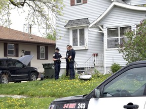 Fort Dodge Police officers Matt Weir, left, Larry Hedlund and Jacob Naatz investigate an accidental shooting, Wednesday, May 9, 2018, in Fort Dodge, Iowa.