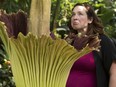 A visitor to the Muttart Conservatory reacts after smelling the conservatory's corpse flower, now named Gagnus, in Edmonton Friday May 25, 2018.