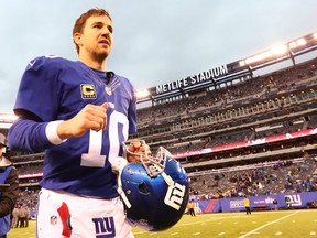 Eli Manning #10 of the New York Giants runs off the field after the 17-6 win against the Detroit Lions their game at MetLife Stadium on December 18, 2016 in East Rutherford, New Jersey.