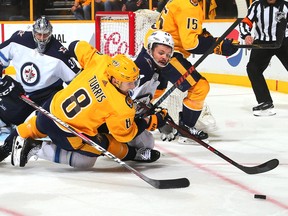 Winnipeg Jets defenceman Josh Morrissey (centre) eyes a loose puck against the Nashville Predators on April 27.