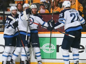 Josh Morrissey, from left, Mark Scheifele, Kyle Connor and Blake Wheeler of the Winnipeg Jets celebrate a goal against the Nashville Predators during the second period of Game 5 of their Western Conference second round series Saturday night at Bridgestone Arena in Nashville, Tenn.