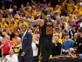 Cleveland Cavaliers forward LeBron James celebrates in front of Toronto Raptors coach Dwane Casey on May 8.