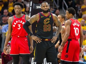 In this May 7 file photo, Cleveland Cavaliers forward LeBron James (centre) smiles against the Toronto Raptors.