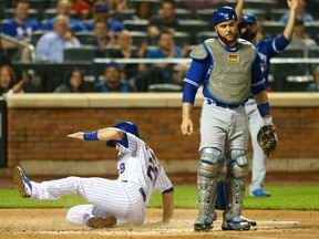 Devin Mesoraco of the Mets scores on  Noah Syndergaard RBI double in the second inning as  Toronto Blue Jays catcher Russell Martin looks on at Citi Field in New York on Tuesday night.