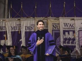 Prime Minister Justin Trudeau acknowledges the crowd after receiving an honorary doctor of laws degree at New York University's commencement ceremony at Yankee Stadium, May 16, 2018 in the Bronx borough of New York City.