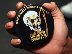 Nine-year-old Daniel Arrieta shows off his "Golden Misfits" puck autographed by Colin Miller of the Vegas Golden Knights during the team's first practice since winning the Western Conference final at City National Arena on Wednesday in Las Vegas. The Golden Knights will play for the Stanley Cup beginning on Monday against the Washington Capitals.