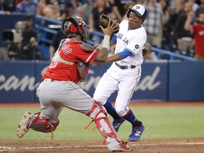 Curtis Granderson of the Blue Jays is tagged out at home plate by Martin Maldonado of the Los Angeles Angels in the ninth inning of their game at Rogers Centre in Toronto on Wednesday night.