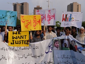 Pakistani protesters carry placards during a demonstration against the killing of a local resident in a car accident involving a U.S. diplomat in Islamabad on April 25, 2018.