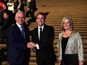 France's President Emmanuel Macron (centre) poses for a photo with Australia's Prime Minister Malcolm Turnbull (left) and his wife Lucy Turnbull (right) outside the Sydney Opera House in Sydney on May 1, 2018.