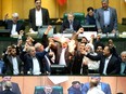A handout picture provided by the Iranian Parliament on May 9, 2018 shows Iranian MPs burning a U.S. flag in the parliament in Tehran.