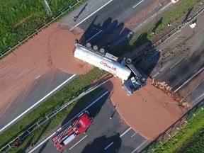 This video grab taken from Polish private TVN channel shows hot chocolate poured out over the A2 highway between Wrzesnia and Slupca near Poznan, western Poland, after a the truck transporting the sweet freight crashed through a traffic barrier on May 9, 2018. After flipping over, the tanker came to rest across lanes, blocking traffic in both directions, police said. The driver was hospitalised with a broken arm. Passing vehicles left chocolate tire marks across several kilometres before authorities closed down the highway.