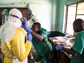 In this handout photograph released by UNICEF on May 13, 2018, health workers wear protective equipment as they prepare to attend to suspected Ebola patients at Bikoro Hospital - the epicentre of the latest Ebola outbreak in the Democratic Republic of Congo - on May 12, 2018.