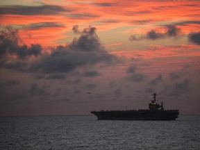 This U.S. Navy photo obtained August 4, 2016, shows the nimitz-class aircraft carrier USS John C. Stennis as it conducts helicopter operations at sunset during Rim of the Pacific 2016 on July 31, 2016 in the Pacific Ocean.