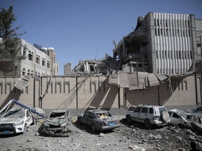 Buildings and vehicles in and around the presidential compound are damaged after airstrikes in Sanaa, Yemen, Monday, May, 7, 2018. Airstrikes by the Saudi-led coalition fighting Yemen's Shiite rebels targeted the presidency building in the heart of the Yemeni capital on Monday, leaving at least at least 6 people dead and 30 wounded, according to health officials.