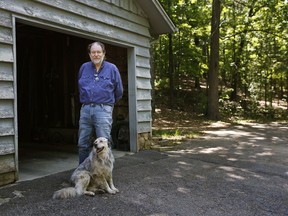 Rick Bragg, 58, stands near his mother's garage with the family dog on Wednesday, May, 9, 2018, in Jacksonville, Ala. Bragg, the Pulitzer Prize winner is spending all the time he can with mother Margaret Bragg, the subject of his latest book, "The Best Cook in the World."