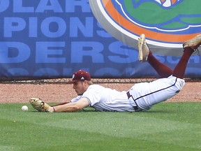 Texas A&M outfielder Zach Deloach makes a diving attempt to catch the fly ball of Mississippi's Will Golsan during the second inning of a Southeastern Conference tournament NCAA college baseball game, Saturday, May 26, 2018, in Hoover, Ala. Golson was later ruled out on a base running error.