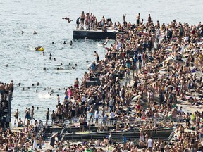 In this Wednesday, May 30, 2018 photo, people are photographed on the beach, during a hot day, in Sorenga, Oslo, Norway.