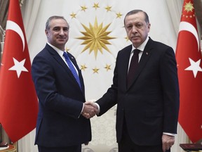 FILE - In this Dec. 5, 2016 file photo, Turkey's President Recep Tayyip Erdogan, right, and Israeli Ambassador Eitan Naeh shake hands after Naeh has presented his letter of credentials, in Ankara, Turkey. Turkey on Tuesday temporarily expelled Israel's ambassador in Ankara after he was called into the ministry, where Turkey relayed its condemnation of Israel's use of deadly force on Gaza protesters. (Presidential Press Service/Pool photo via AP, File)