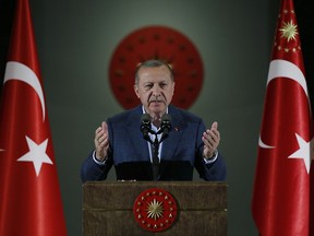 Turkey's President Recep Tayyip Erdogan speaks during an Iftar, the evening meal breaking the Ramadan fast, at his palace in Ankara, Turkey, Saturday, May 19, 2018. Erdogan called snap presidential and parliamentary elections a year and a half before schedule. The elections will usher in a new executive presidential system that increases the powers of the president. (Presidential Press Service/Pool via AP)