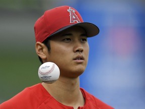 Los Angeles Angels' Shohei Ohtani, of Japan, tosses a ball in the air as he warms up prior to a baseball game against the Tampa Bay Rays, Saturday, May 19, 2018, in Anaheim, Calif.