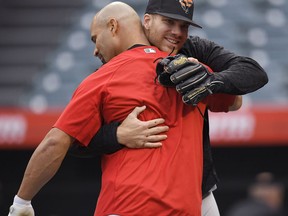 Los Angeles Angels' Albert Pujols, left, hugs Baltimore Orioles first baseman Chris Davis during batting practice prior to a baseball game against the Baltimore Orioles Tuesday, May 1, 2018, in Anaheim, Calif.