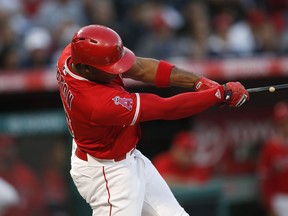 Los Angeles Angels' Justin Upton swings for a two-run home run during the first inning of a baseball game against the Houston Astros on Tuesday, May 15, 2018, in Anaheim, Calif.