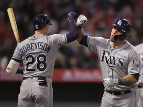 Tampa Bay Rays' Wilson Ramos, right, is congratulated by Daniel Robertson after hitting a two-run home run during the third inning of a baseball game against the Los Angeles Angels, Friday, May 18, 2018, in Anaheim, Calif.