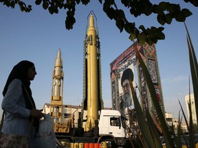 A Ghadr-H missile, centre, a solid-fuel surface-to-surface Sejjil missile and a portrait of Supreme Leader Ayatollah Ali Khamenei are displayed at Baharestan Square in Tehran, Iran, in a Sept. 24, 2017 file photo.