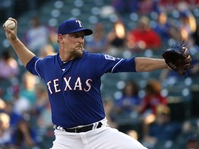 Texas Rangers starting pitcher Austin Bibens-Dirkx (56) delivers against the Kansas City Royals during the first inning of a baseball game Thursday, May 24, 2018, in Arlington, Texas.