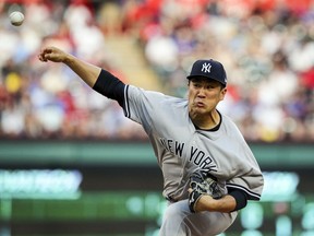 New York Yankees starting pitcher Masahiro Tanaka (19) delivers a pitch against the Texas Rangers in the first inning of a baseball game Monday, May 21, 2018, in Arlington, Texas.