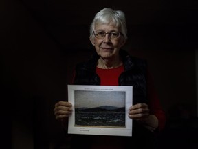 Glenna Gardiner holds a picture of her painting in Edmonton, on March 28, 2018.