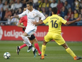 Real Madrid's Cristiano Ronaldo, left, tries to control the ball against Villarreal's Rodrigo, right, during a Spanish La Liga soccer match at the Ceramica stadium in Villarreal, Spain, Saturday, May 19, 2018.