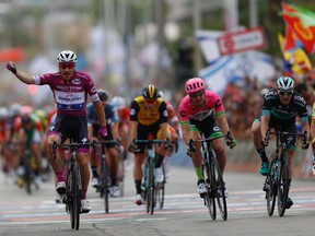 Italian cyclist Elia Viviani crosses the finish line during the third stage of 2018 Giro d'Italia, Tour of Italy cycling race, in the Red Sea city of Eilat, southern Israel, Sunday, May 6, 2018.
