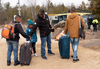 A family, claiming to be from Colombia, gets set to cross the border into Canada from the United States as asylum seekers on April 18, 2018 near Champlain, N.Y.
