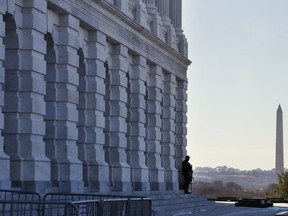 FILE - In this Friday, Jan. 19, 2018, file photo, a Capitol Police officer guards his post, on Capitol Hill in Washington. The U.S. Capitol Police are among the seven winners of this year's Jefferson Muzzles, tongue-in-cheek awards bestowed annually by a free-speech group. The Charlottesville, Virginia-based Thomas Jefferson Center for the Protection of Free Expression announced the "winners" on Sunday, May 6, 2018.
