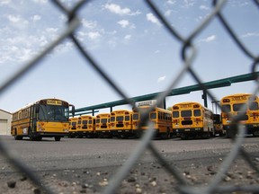 School buses sit idle at a main terminal as the statewide teachers strike enters a fourth day Tuesday, May 1, 2018, in Phoenix.