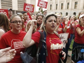 Arizona teacher Aurelia Ionescu, front right, chants with other teachers as protest organizers announce their intention to go back to work as the state-wide teachers strike enters a fourth day at the Arizona Capitol, Tuesday, May 1, 2018, in Phoenix. Organizers vowed to continue the fight for more school funding but stated that they would go back to work once the new state budget is passed.