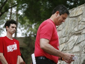 Teacher protest organizers Joe Thomas, right, president of the Arizona Education Association, and Noah Karvelis, left, who helped organize Arizona Educators United, arrive at a news conference to announce their intention to get Arizona teachers back to work if lawmakers pass a school funding plan, as the state-wide teachers strike enters a fourth day at the Arizona Capitol, Tuesday, May 1, 2018, in Phoenix.