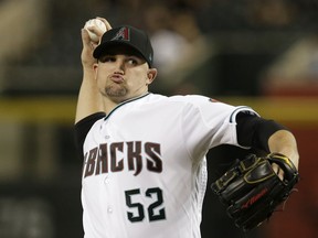 Arizona Diamondbacks pitcher Zack Godley throws during the first inning of the team's baseball game against the Cincinnati Reds, Tuesday, May 29, 2018, in Phoenix.