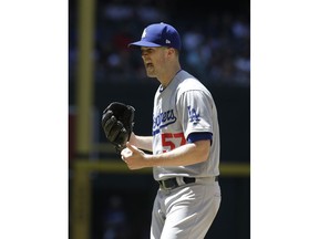 Los Angeles Dodgers pitcher Alex Wood reacts after a warm up pitch in the fifth inning of a baseball game against the Arizona Diamondbacks, Thursday, May 3, 2018, in Phoenix.