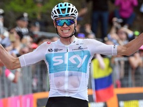 Britain's Chris Froome celebrates as he crosses the finish line to win the the 19th stage of the Giro d'Italia cycling race, from Venaria Reale to Bardonecchia, in Bardonecchia, Italy, Friday, May 25, 2018.