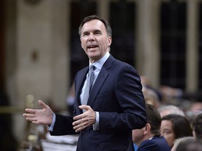 It won't be known until September what a carbon tax will cost Canadians, says Finance Minister Bill Morneau, seen during question period in the House of Commons on April 24, 2018.