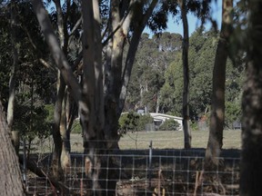 A property is seen from a police roadblock where police are investigating the death of seven people in a suspected murder-suicide in Osmington, east of Margaret River, 162 miles (260 kms.) south west of Perth, Friday, May 11, 2018. Seven people including four children were found dead with gunshot wounds at a rural property in southwest Australia in what could be the country's worst mass shooting in 22 years.