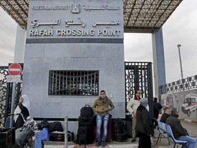 FILE - In this Sunday, Dec. 21, 2014, file photo, Palestinians wait to cross the border to the Egyptian side at Rafah crossing in the southern Gaza Strip. Egypt's President Abdel Fatah el-Sissi says he has ordered the Rafah crossing point with Gaza strip be opened for the whole Muslim holy month of Ramadan, the longest time since Hamas took over the territory in 2007.