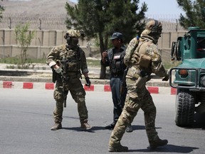 Security personnel arrive at the site of an attack in the Afghan Interior Ministry in Kabul, Afghanistan, Wednesday, May 30, 2018. The area around the Interior Ministry has been rocked by several loud explosions and gunfire, in what appears to be the latest in a series of attacks in Kabul.