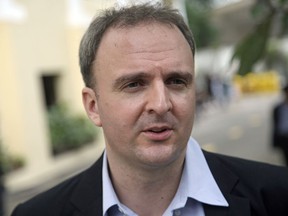 FILE - In this Nov. 3, 2016, file photo, British labor rights activist Andy Hall talks to reporters at the Supreme Court in Bangkok. A Thai court of appeal dismissed criminal defamation charges against Hall who was sued by a fruit packaging company after he alleged human rights violations at its factory.