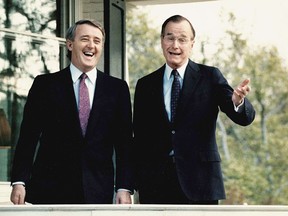 George H.W. Bush, right, shares a laugh with Brian Mulroney following a question from a reporter outside Bush's residence in Washington, DC., on April 28,1988.