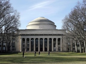 FILE - In this April 3, 2017 file photo, students walk past the "Great Dome" atop Building 10 on the Massachusetts Institute of Technology campus in Cambridge, Mass. The Massachusetts Supreme Judicial Court ruled Monday, May 7, 2018, that MIT cannot be held responsible for the 2009 death of graduate student Han Nugyen who killed himself. His family's lawsuit said that the school knew he was a suicide risk and could have prevented his death.